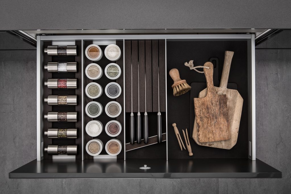 SieMatic - dark smoked cheshunt lining and moveable aluminium panels spice mills and knife holder
